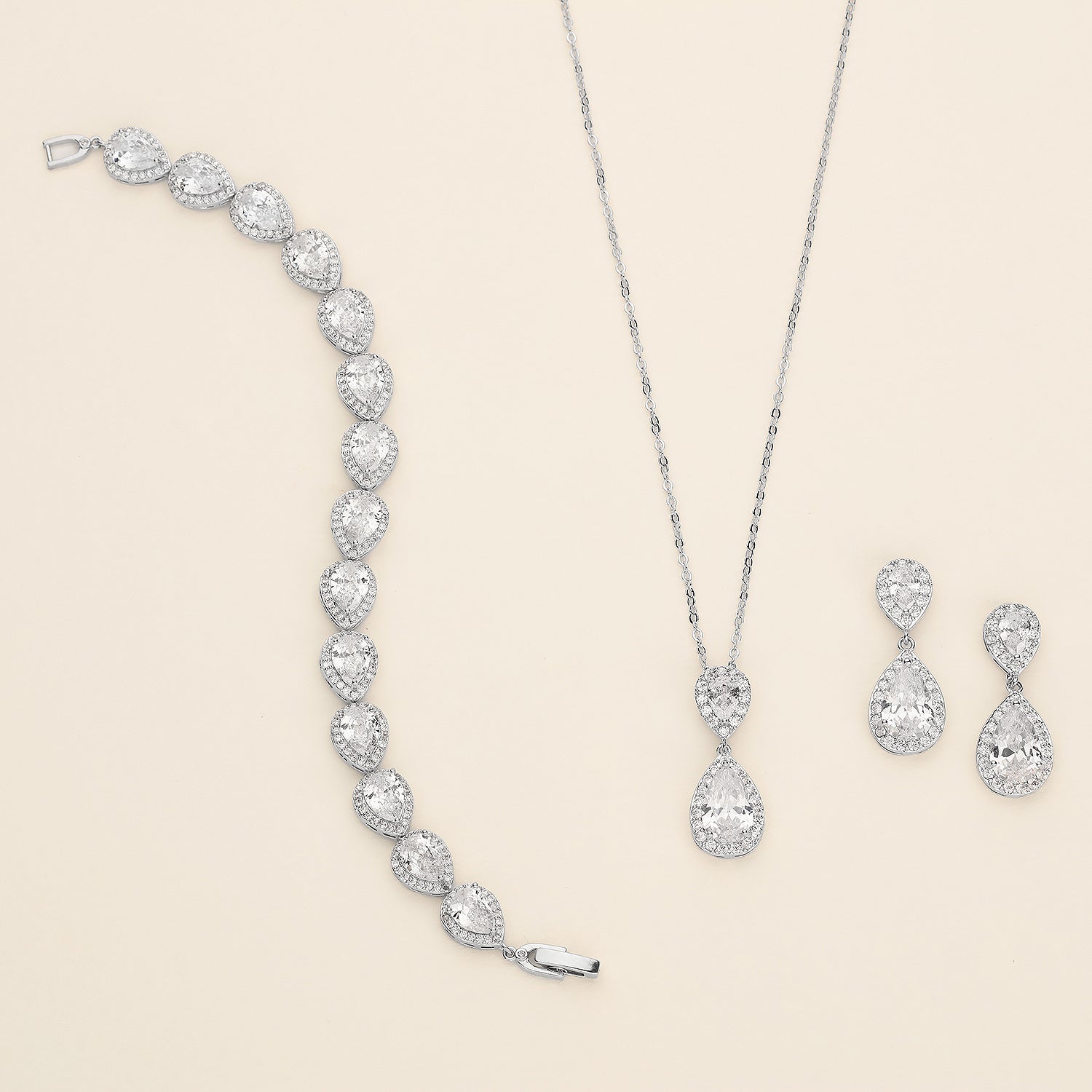 a necklace, earrings, and ring are shown on a white background