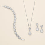 a necklace, earrings, and ring are shown on a white background