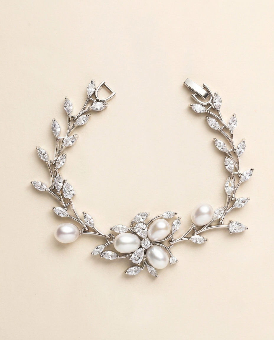 A bracelet adorned with a floral design and pearls.