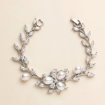 A bracelet adorned with a floral design and pearls.