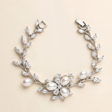 A bracelet adorned with a floral design and pearls.