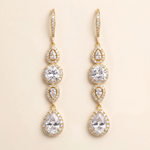 A pair of elegant gold earrings with multiple tiers of small, clear gemstones.