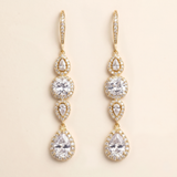 A pair of elegant gold earrings with multiple tiers of small, clear gemstones.