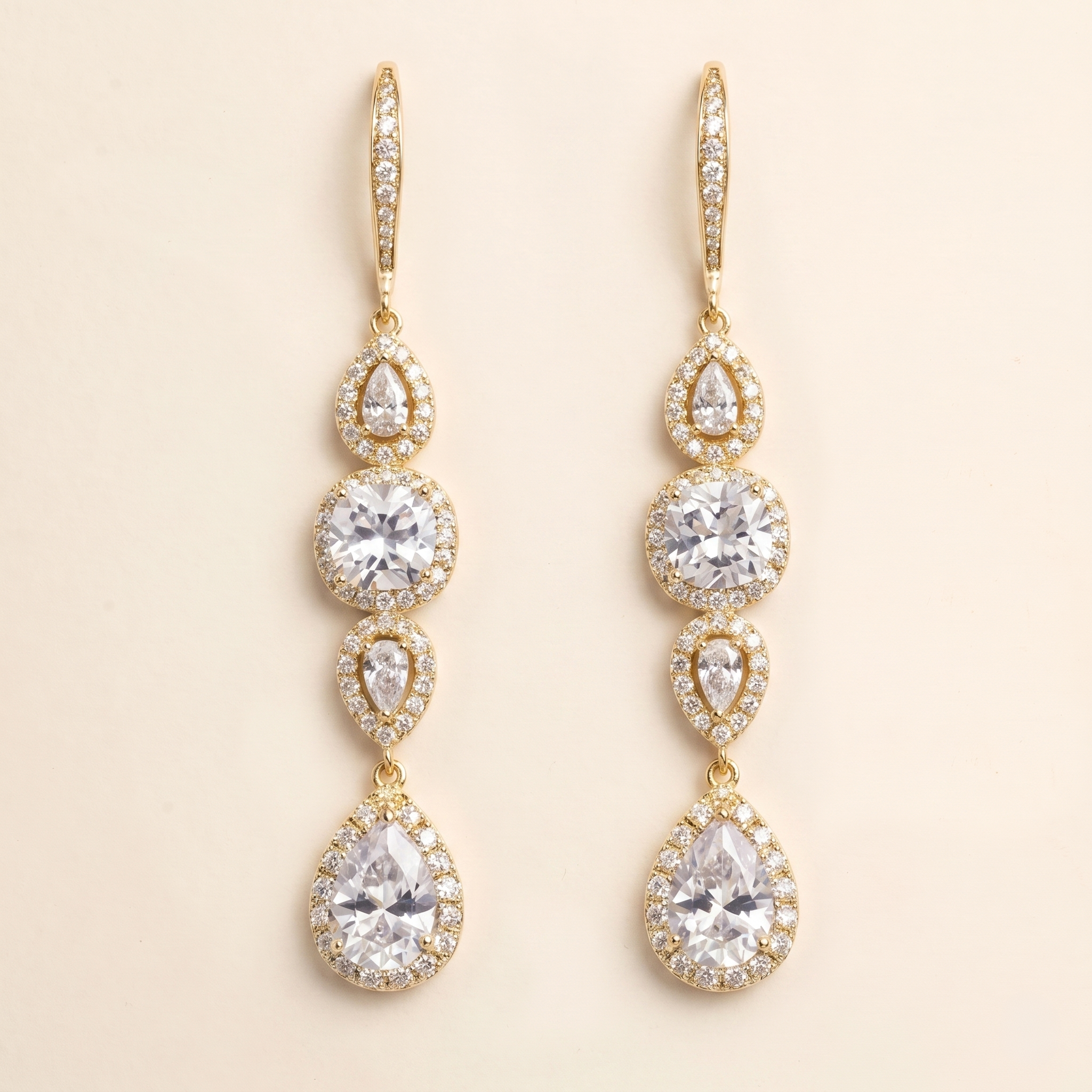 A pair of elegant gold earrings with multiple tiers of small, clear gemstones.