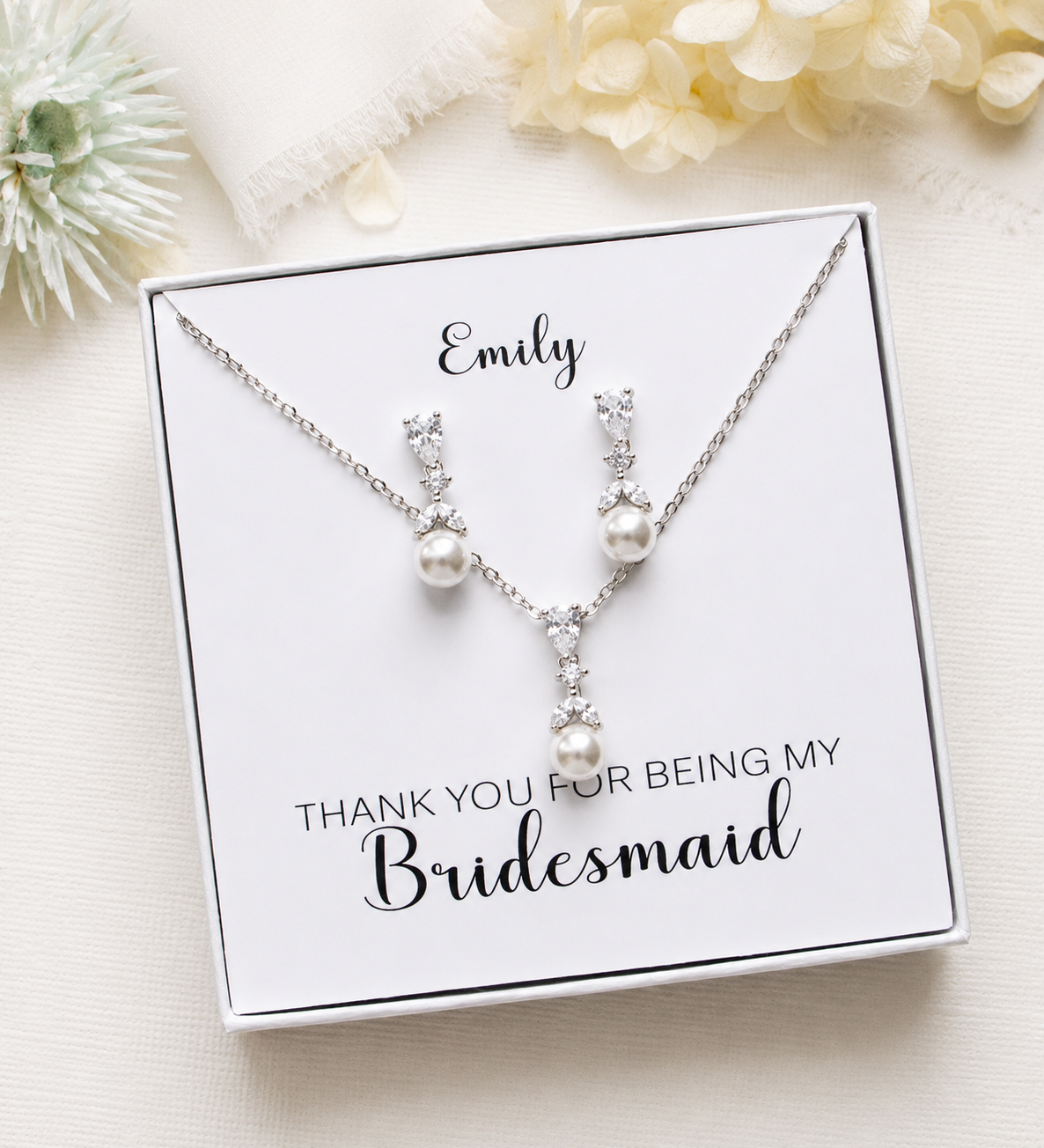 A necklace and earrings set in a white box, accompanied by a personalized message that reads "Thank you for being my Bridesmaid".