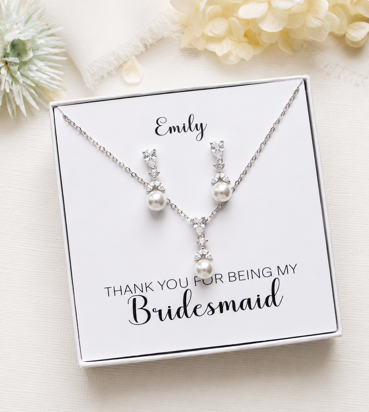 A necklace and earrings set in a white box, accompanied by a personalized message that reads "Thank you for being my Bridesmaid".