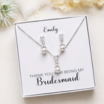 A necklace and earrings set in a white box, accompanied by a personalized message that reads "Thank you for being my Bridesmaid".
