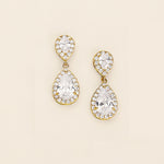 a pair of diamond earrings on a white background