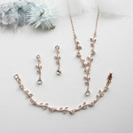 a necklace and earring set on a white surface