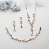 a necklace and earring set on a white surface