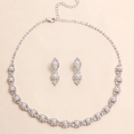 A necklace and earrings set made of silver and white pearls, with a chain and clasp.