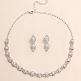 A necklace and earrings set made of silver and white pearls, with a chain and clasp.