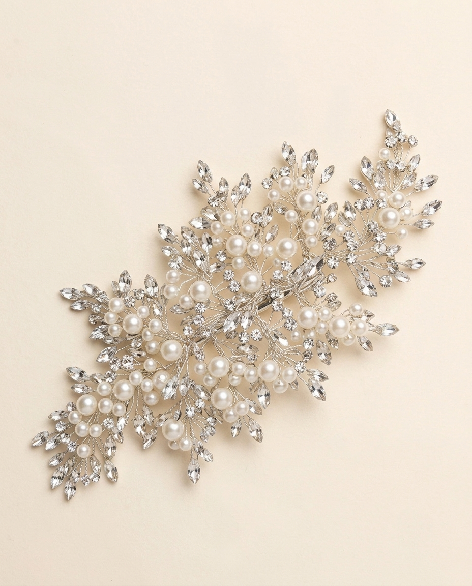 a decorative piece of jewelry with a combination of pearls and crystals, including a large cluster of pearls and smaller crystals arranged in a visually appealing manner.