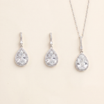 A necklace and earrings set made of silver and crystal materials.