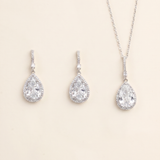 A necklace and earrings set made of silver and crystal materials.
