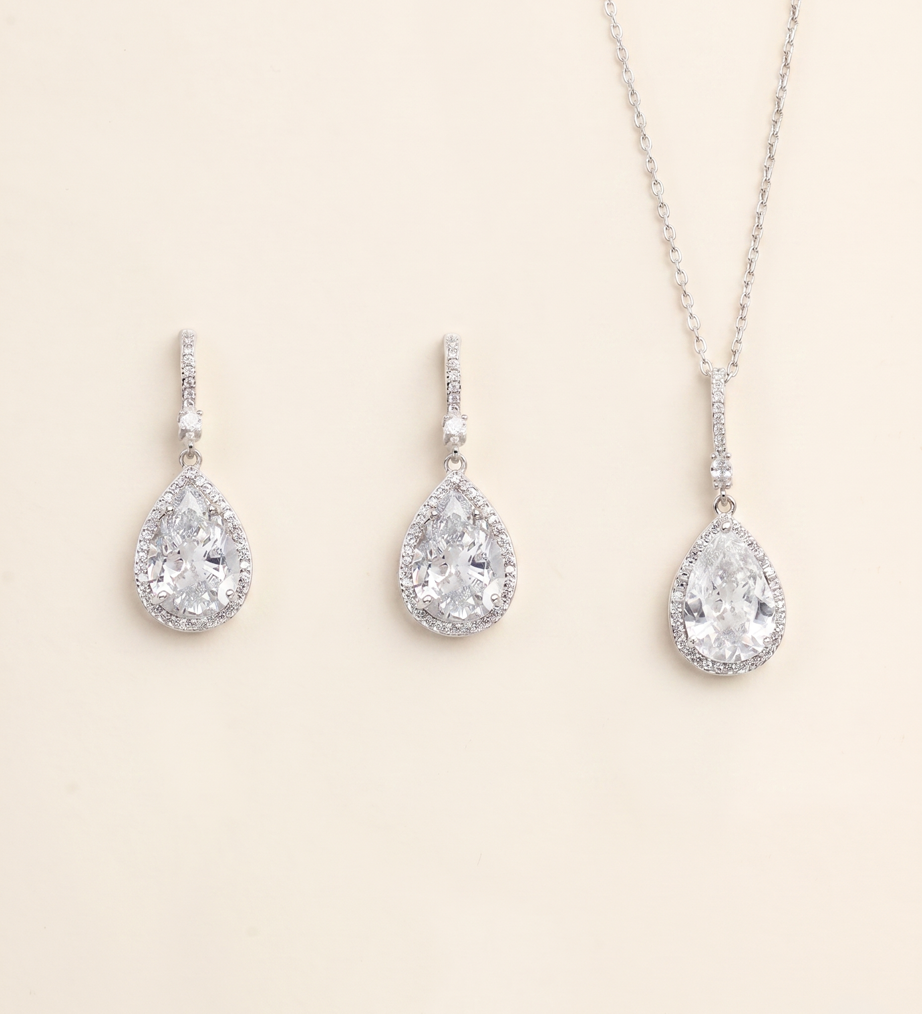 A necklace and earrings set made of silver and crystal materials.