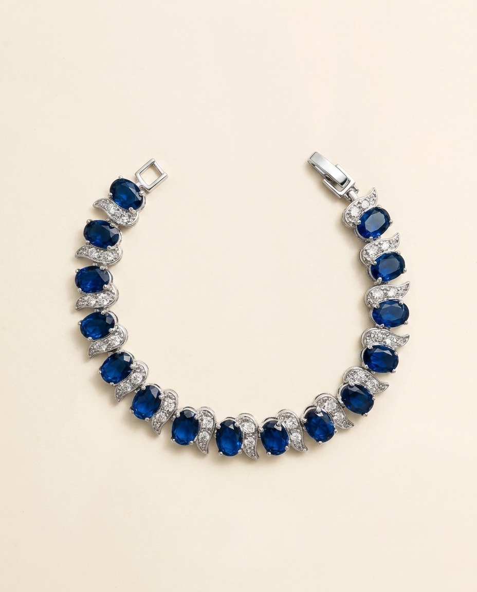A bracelet with a row of blue sapphires and diamonds set in silver.