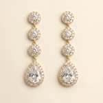 A pair of elegant gold earrings with a row of small, round diamonds set in the center of each pendant.