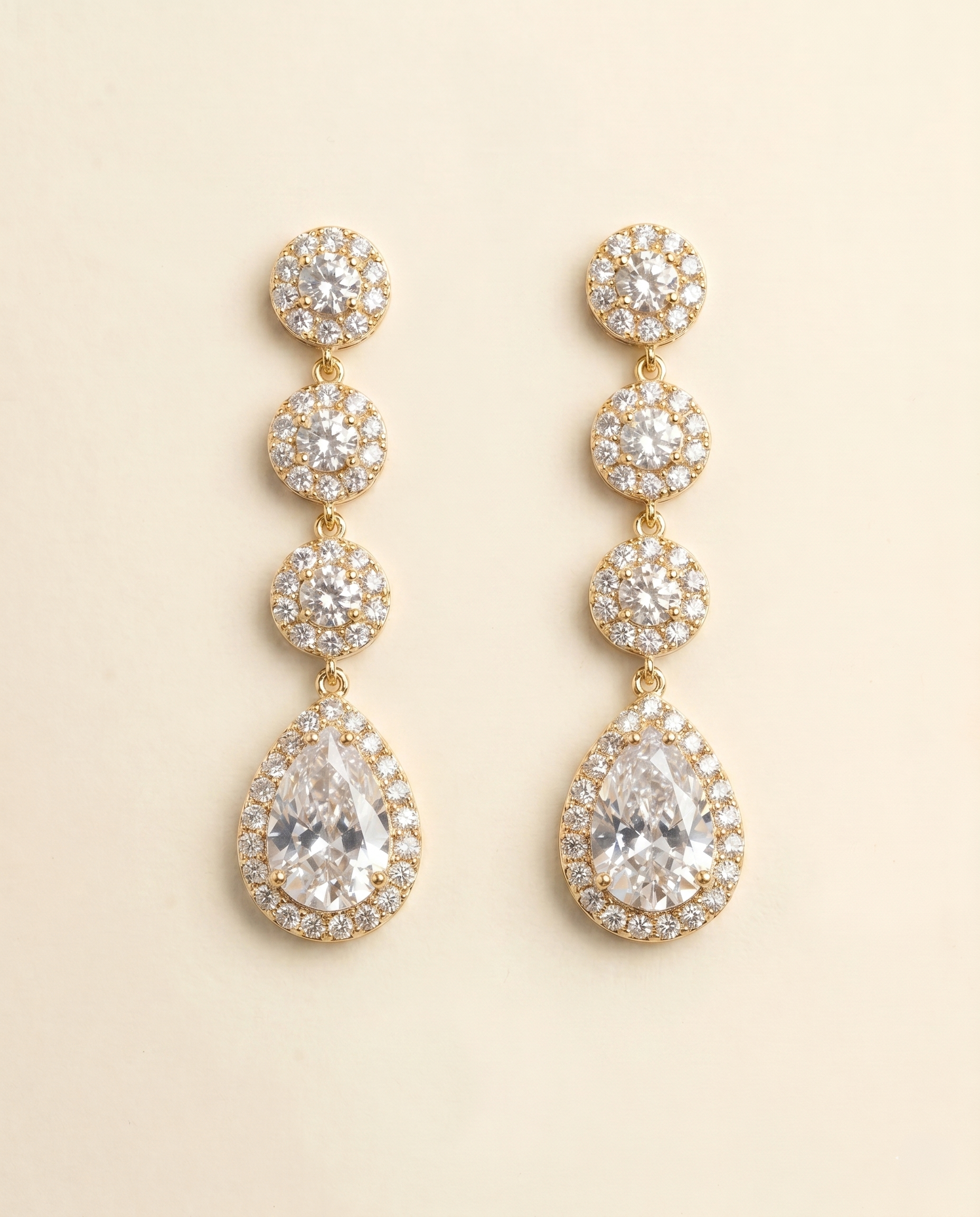 A pair of elegant gold earrings with a row of small, round diamonds set in the center of each pendant.