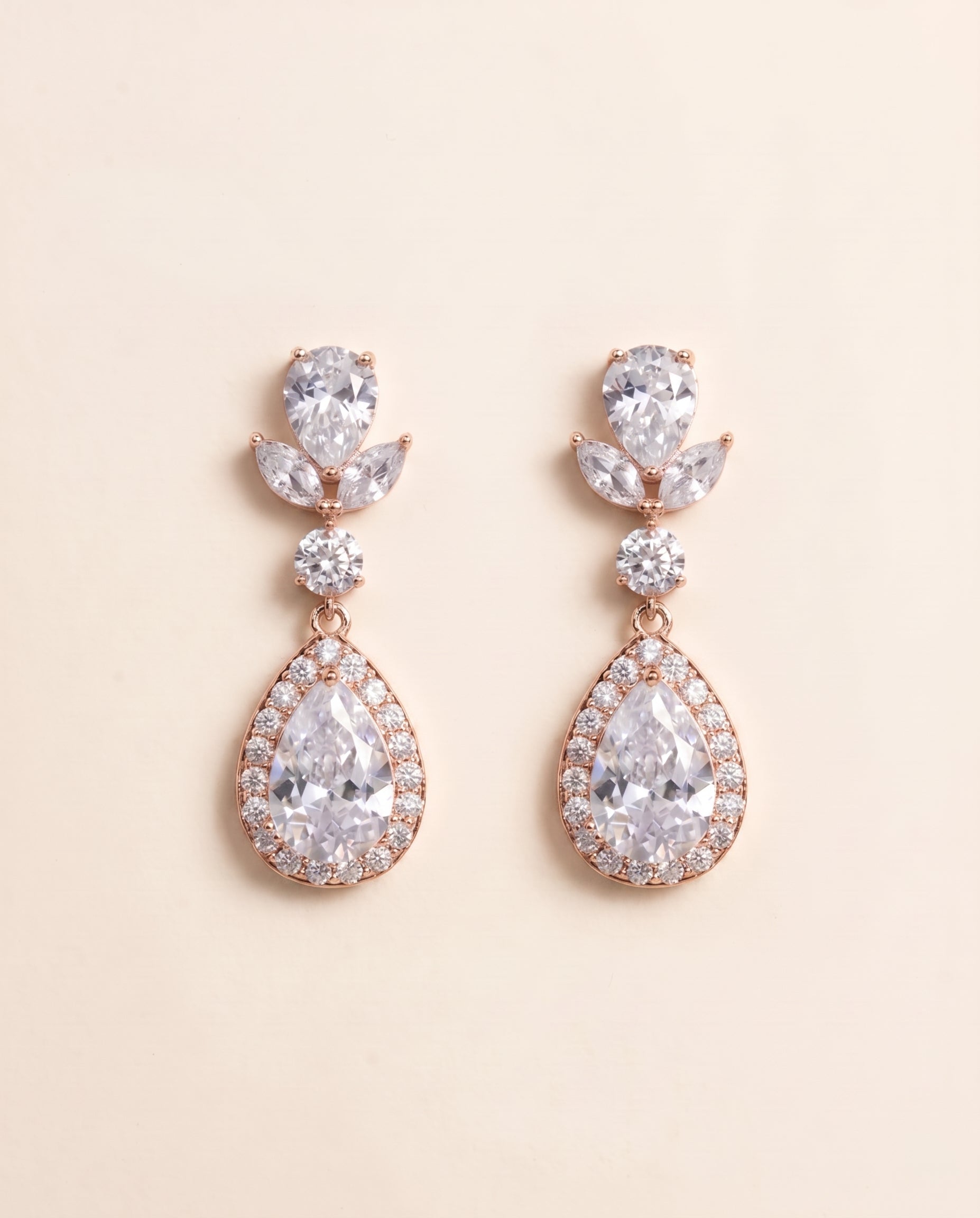 A pair of elegant earrings with large, clear gemstones set in a delicate, ornate design.