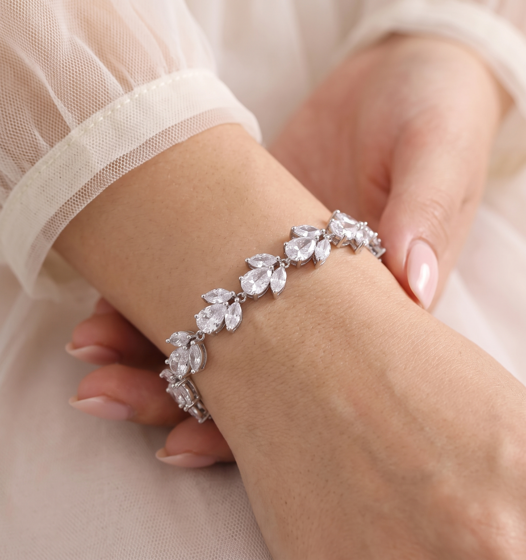 A close-up image of a person's hand wearing a bracelet with a row of small, clear gemstones.