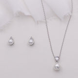 a necklace, earrings, and ring on a white background