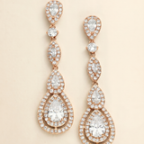 a pair of elegant gold earrings with numerous small diamonds set in a circular pattern. The earrings have a long, dangling design with multiple tiers of diamonds, creating a sophisticated and eye-catching piece of jewelry.
