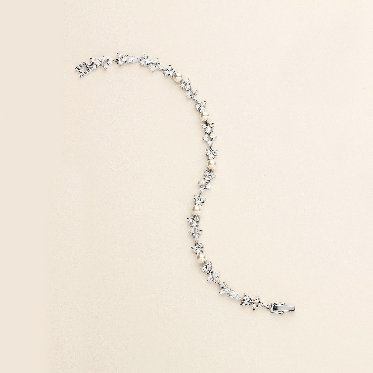 a white pearl necklace with a silver clasp