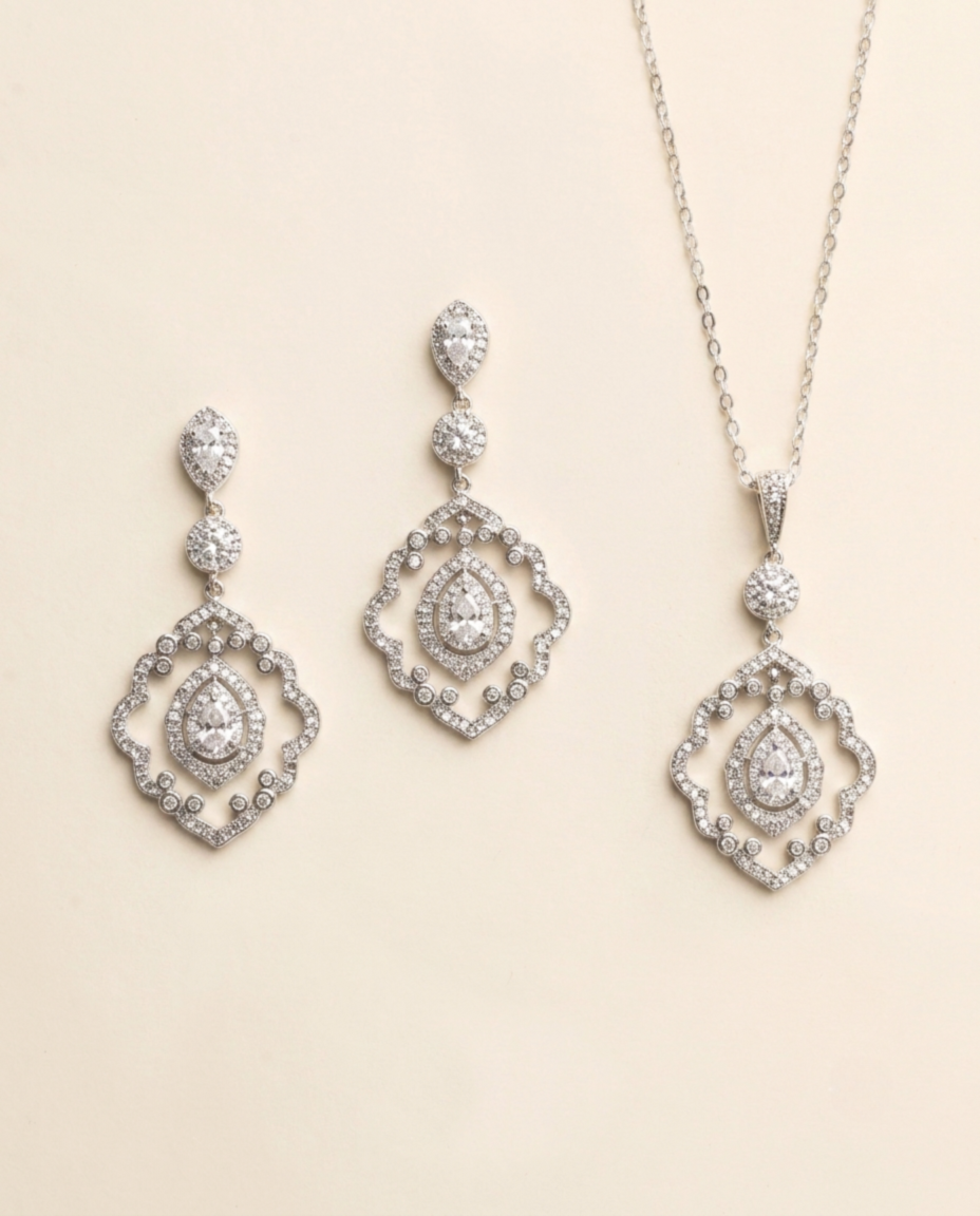 a set of elegant jewelry pieces, including earrings and a necklace, both adorned with sparkling diamonds.