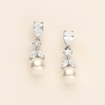 a pair of pearl and diamond earrings