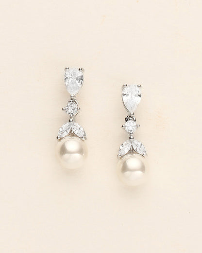 a pair of pearl and diamond earrings