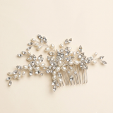 A decorative hair accessory with a combination of pearls, crystals, and branches.