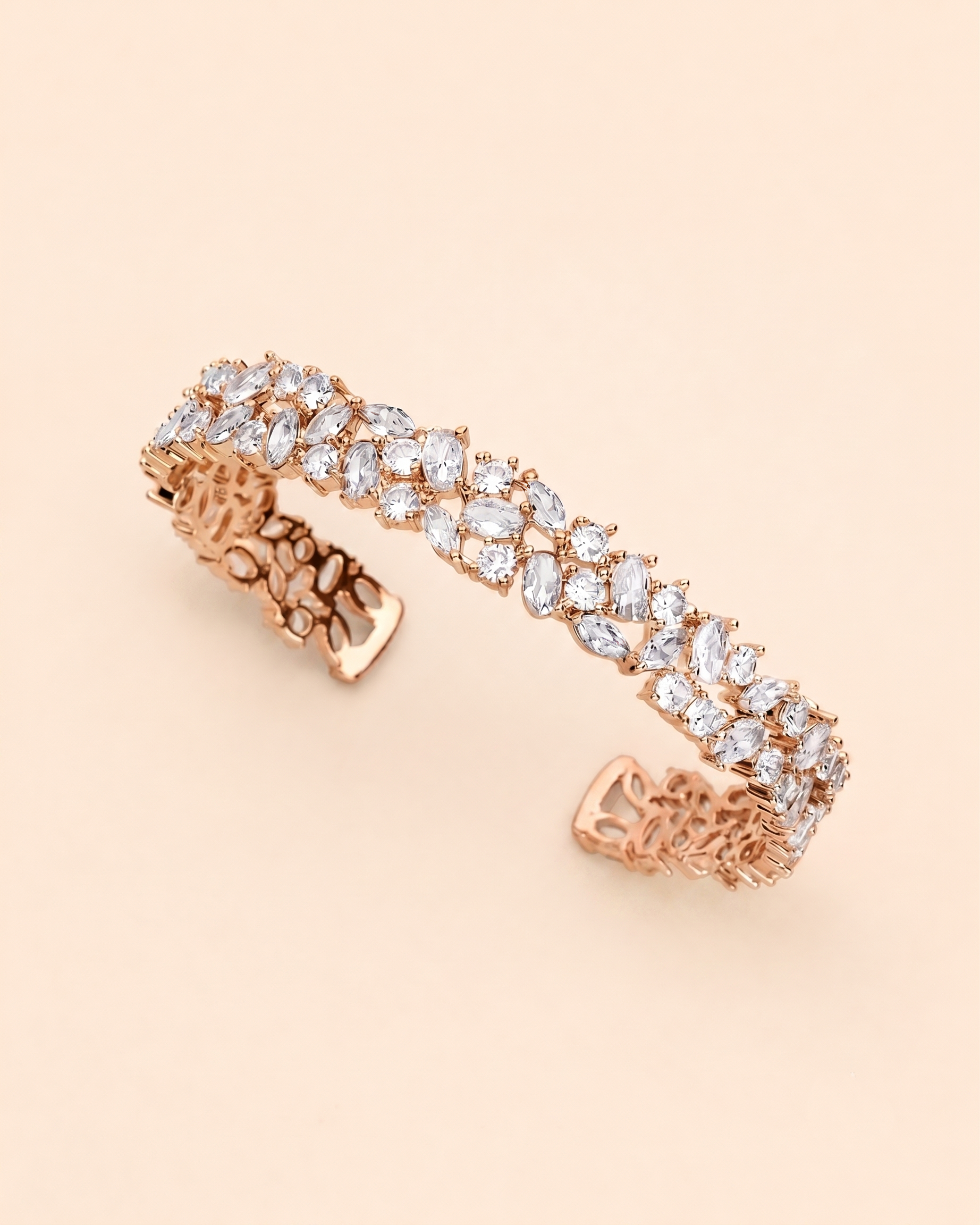 A delicate gold bracelet adorned with numerous small, clear gemstones.