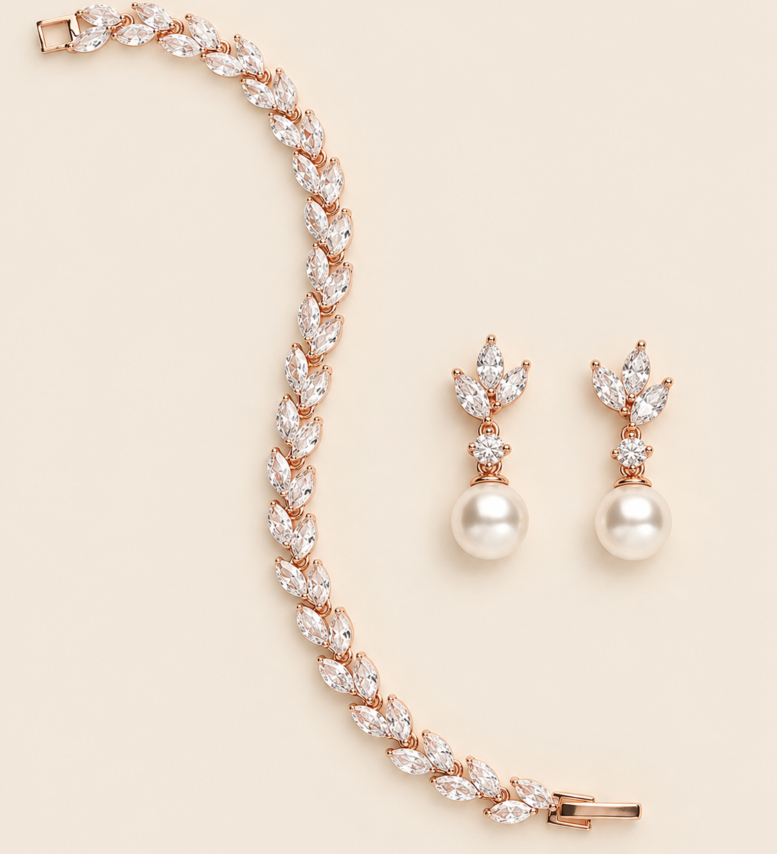 Eve rose gold pearl-drop earring pair and marquise crystal bracelet on a cream background.