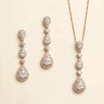 a set of elegant jewelry pieces, including a necklace and earrings, both adorned with numerous sparkling diamonds.