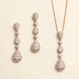 a set of elegant jewelry pieces, including a necklace and earrings, both adorned with numerous sparkling diamonds.