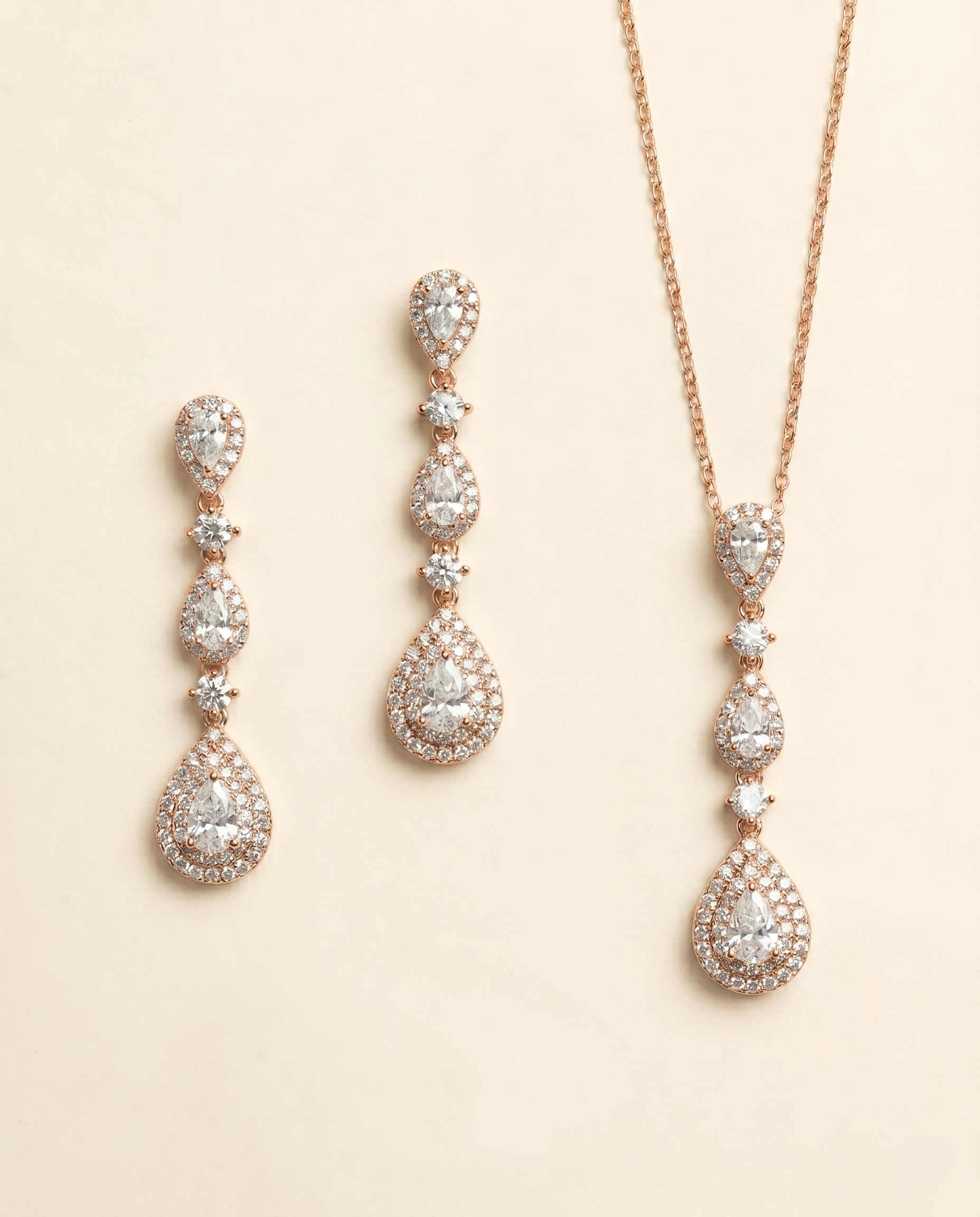 a set of elegant jewelry pieces, including a necklace and earrings, both adorned with numerous sparkling diamonds.