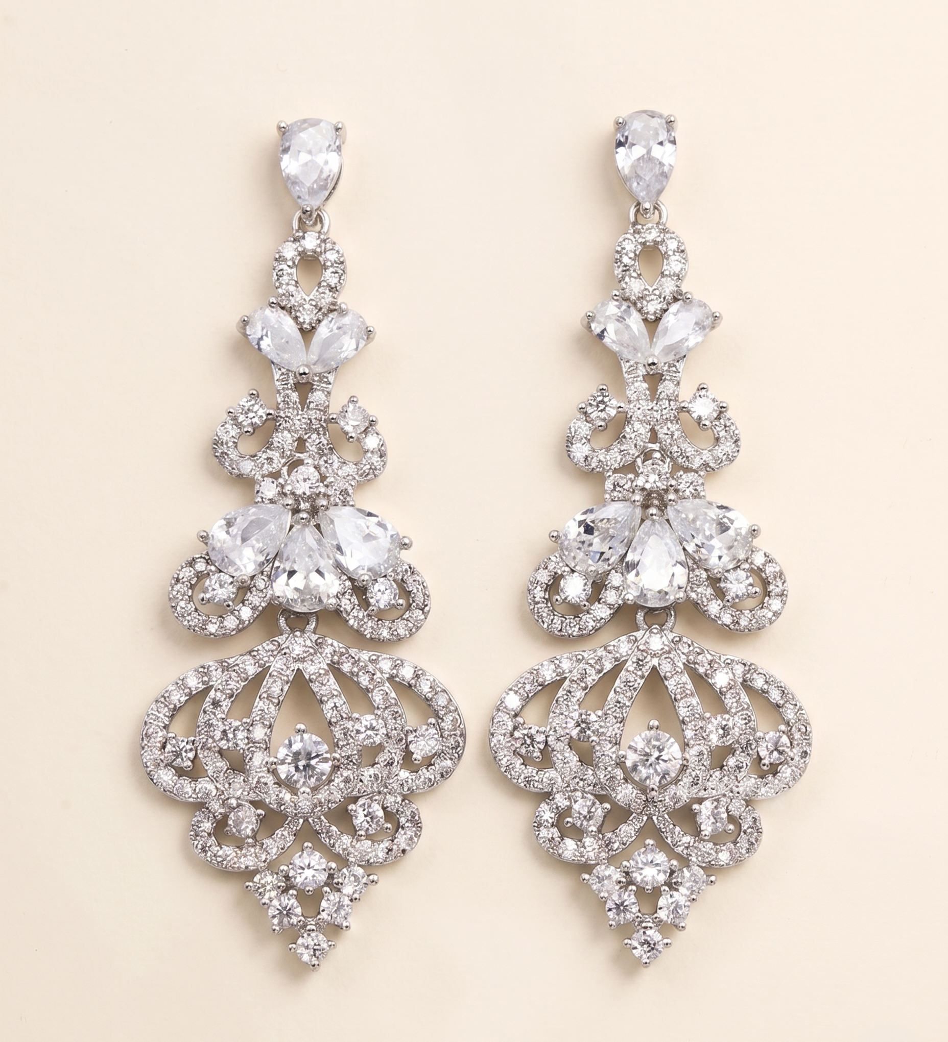 A pair of elegant diamond earrings with intricate designs and sparkling crystal elements.
