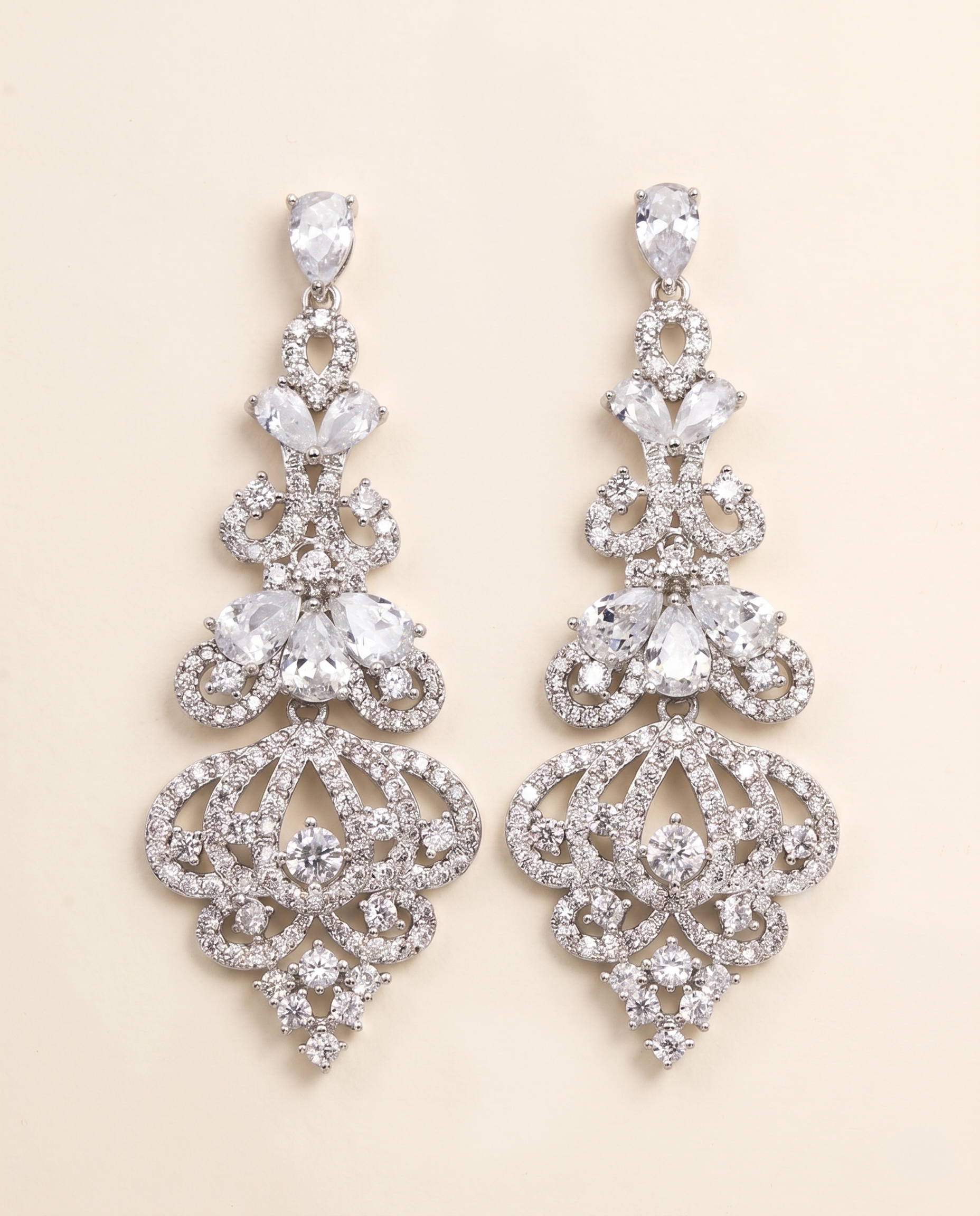 A pair of elegant diamond earrings with intricate designs and sparkling crystal elements.