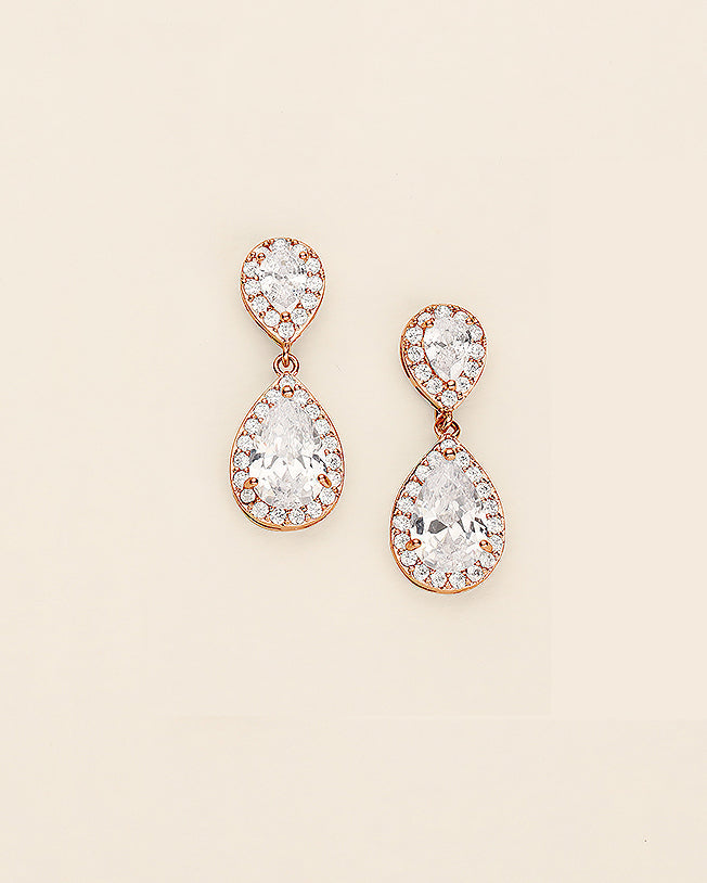 a pair of diamond earrings on a white background