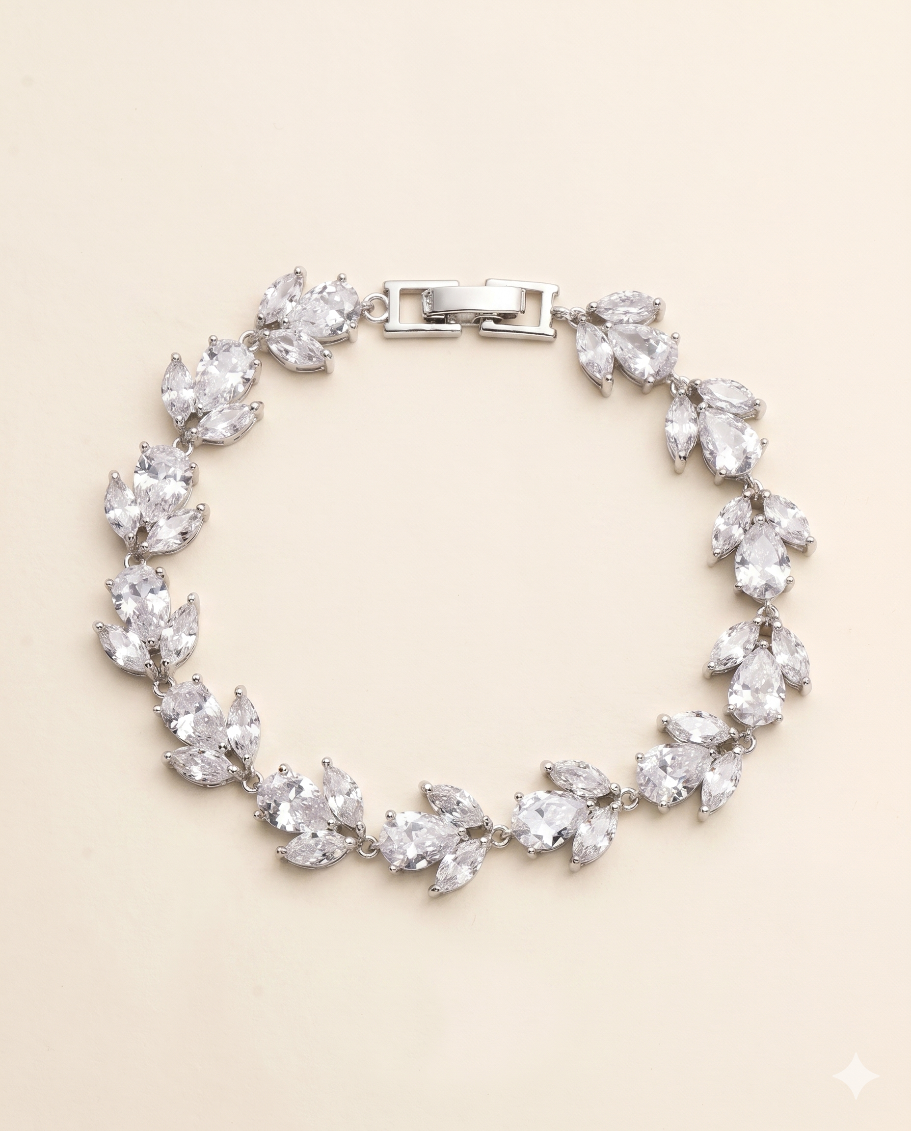 A silver bracelet adorned with numerous clear gemstones, including large and small diamonds, arranged in a circular pattern.