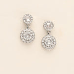 a pair of diamond earrings on a white background