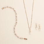 a necklace and earring set with pearls