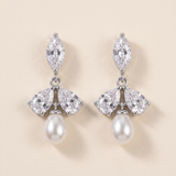 A pair of elegant earrings with a combination of pearls and diamonds.