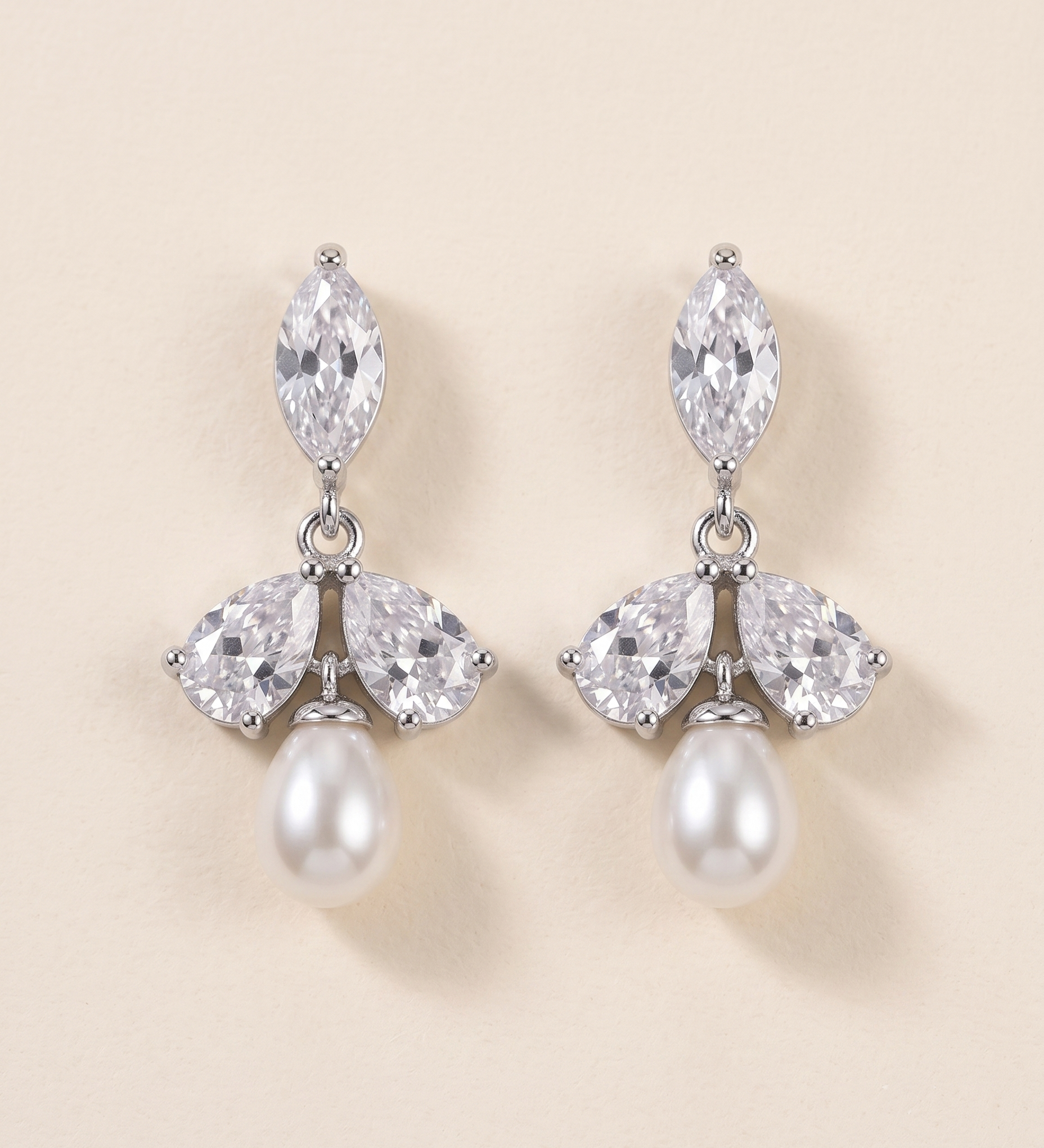 A pair of elegant earrings with a combination of pearls and diamonds.
