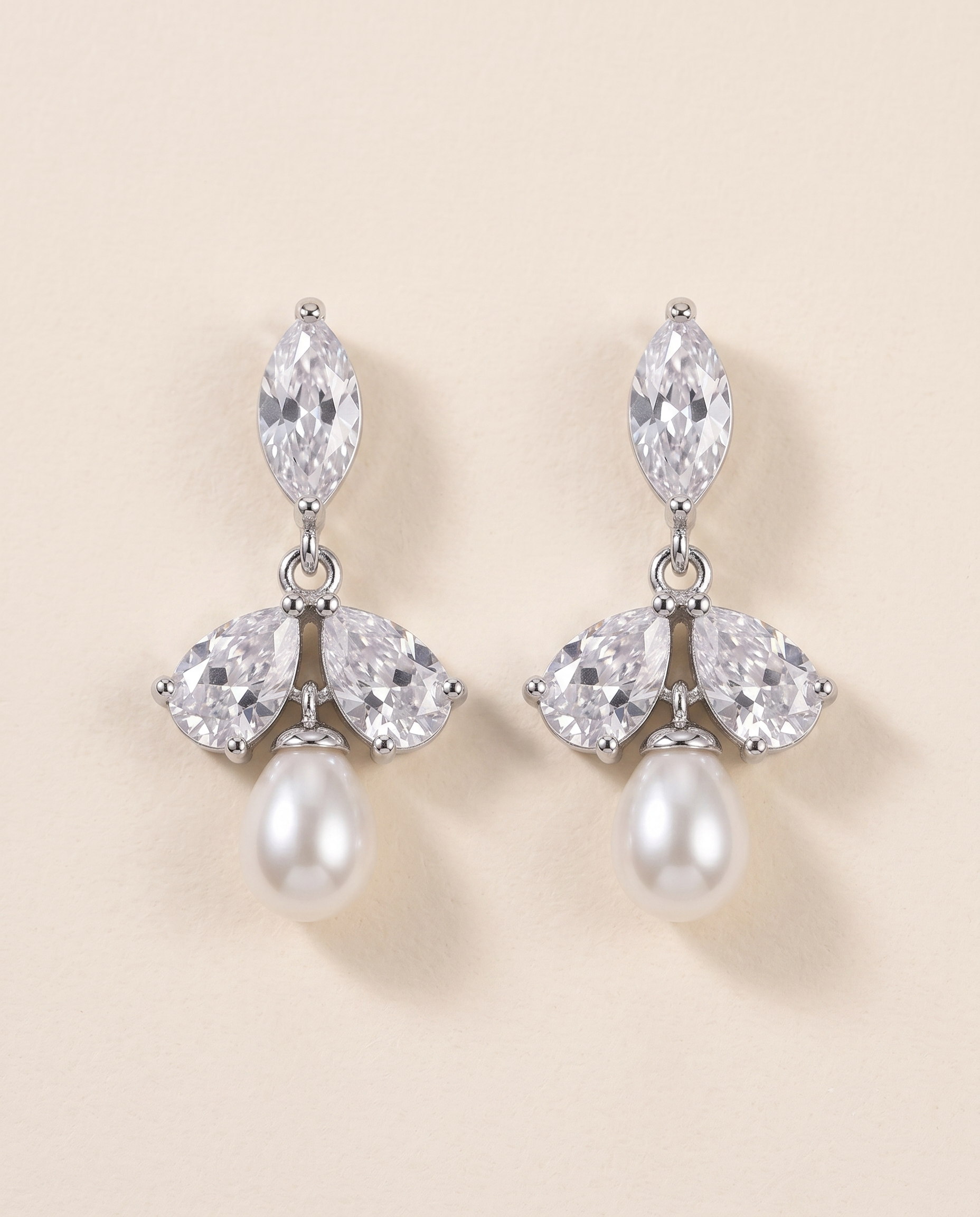 A pair of elegant earrings with a combination of pearls and diamonds.
