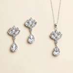 a set of elegant jewelry pieces, including a necklace and earrings, all featuring large, sparkling crystal stones.
