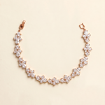 A delicate necklace with a row of small, clear gemstones arranged in a floral pattern.