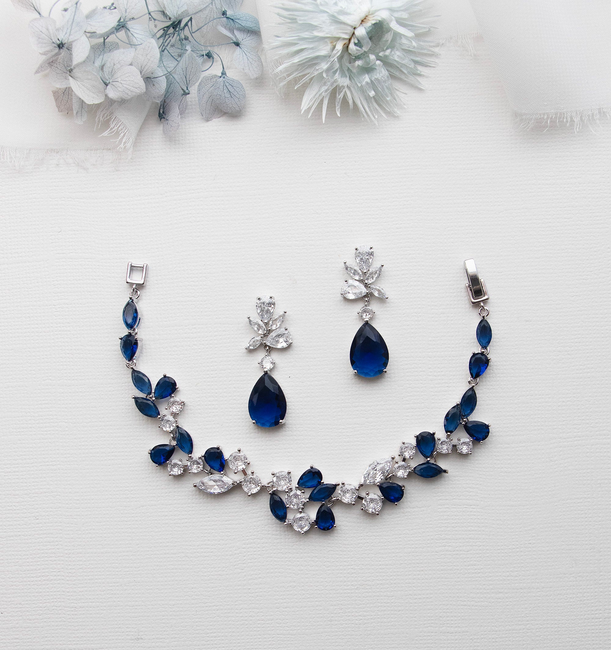 a necklace and earring set with blue stones