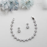 a necklace and earring set on a white surface